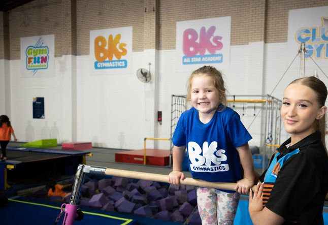Children engaging in gymnastics, vibrant and active environment, professional coaching